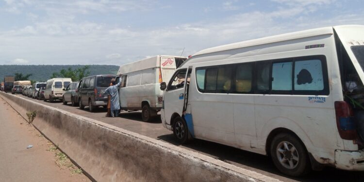 PHOTOS: Commuters trapped on flooded Abuja-Lokoja road