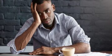 tired unhappy young manager with headache having exhausted overworked look 273609 9300